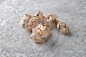 Balls of crumpled old paper on a concrete table.