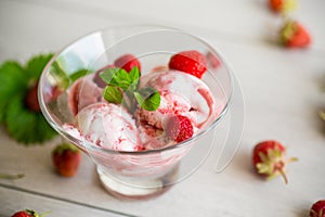 Balls of homemade strawberry ice cream in a bowl