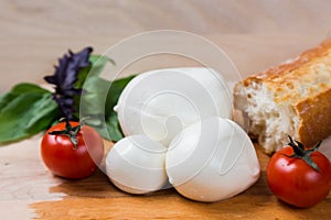 Balls mozzarella different size with tomatoes cherry, bread and