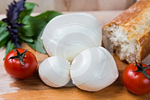 Balls mozzarella different size with tomatoes cherry, bread and