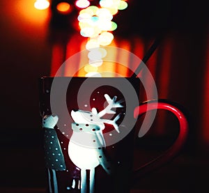 Balls of smoke deriving from tea cup with cartoon deer design. photo