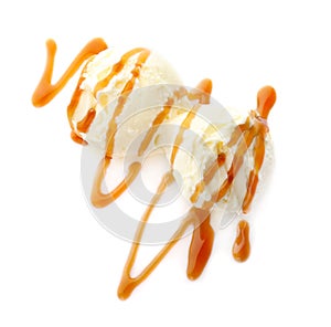 Balls of tasty vanilla ice cream with caramel topping on white background