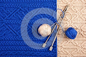 Balls of thread with knitting needles