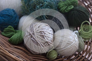 Balls of wool in basket - mostly greens