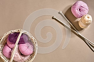 Balls of woolen threads and knitting needles. Scandinavian style. Threads for knitting in a basket.