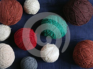 Balls of yarn in different colors on a background of dark blue
