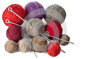 Balls of yarn in different colors with knitting needles.
