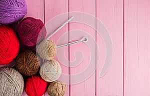 Balls of yarn in different colors with knitting needles photo