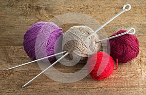 Balls of yarn in different colors with knitting needles