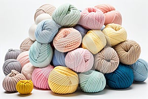 Balls of yarn in light pastel colors on white background. Skeins of yarn, needles and tools for needlework