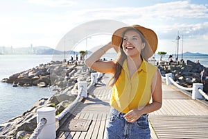 Balneario Camboriu travel lifestyle woman walking happy on pier. Brazilian caucasian girl smiling relaxing in harbor city in