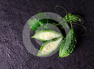 Balsam Pear on wet black stone plate background