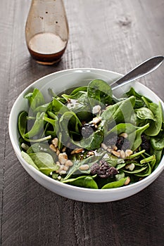 Balsamic Spinach Salad with a glass flask of dressing