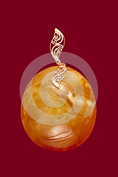 Baltic amber closeup on red background