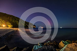 Baltic cliff in Gdynia Orlowoat night with Northerm lights over the sea. Poland photo