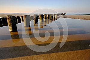 Baltic coast at sunset, breakwater, beach, Kolobrzeg, Poland.