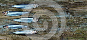 Baltic herring sprats wooden table aged background photo