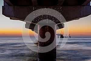 Baltic sea at beautiful sunset in Miedzyzdroje beach. Polish baltic coast. Famous city among the tourist. Pier at sunset