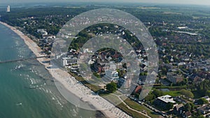 Baltic sea coastline in Scharbeutz, Germany. Aerial drone flying above tourist sea summertime beach, dolly in, day