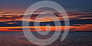 Baltic Sea panorama with lighthouse and ships in the sunset in SwinemÃ¼nde. Swinoujscie, Poland