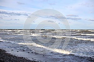 Baltic sea shoreside view with waves and cloudy weather