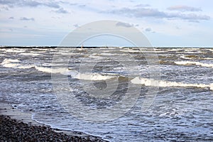 Baltic sea shoreside view with waves and cloudy weather