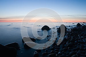 Baltic seaside with stones after sunset