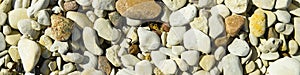 Baltick Sea beach. Natural small pebbles on the rocky seashore, panorama. can be usedas texture or backround.
