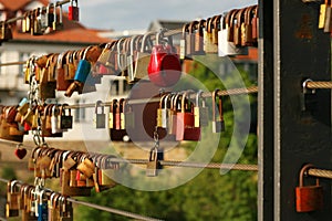 Bamberg, northern Bavaria, Upper Franconia, Germany, 11 of June 2022. Lovelocks hanging on the railings of the Chain suspension