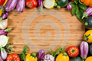 Bamboe plate with copy space, restautant concept with fresh organic vegetables - round courgette, small eggplants, tomatoes, diet