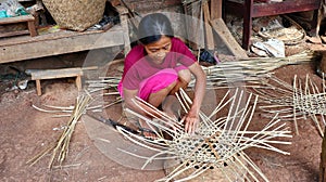 Bamboo basket craftswoman while doing his work