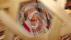 Bamboo basket craftswoman while doing his work