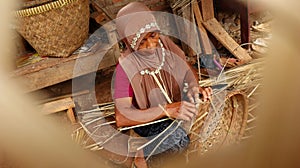 Bamboo basket craftswoman while doing his work