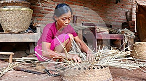 Bamboo basket craftswoman while doing his work