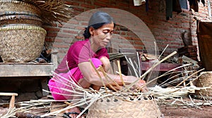 Bamboo basket craftswoman while doing his work