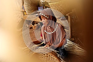 Bamboo basket craftswoman while doing his work