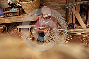 Bamboo basket craftswoman while doing his work