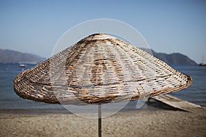 Bamboo beach umbrella on the background of the sea, beach.