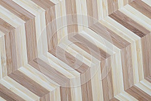 Bamboo blocks in two bright colors arranged in a chevron pattern. Wooden background texture