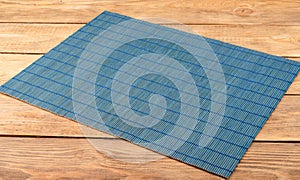 Bamboo blue food mat on wooden background