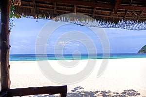 A bamboo chair in the middle of an empty exotic beach. View from the bungalow to the Sin Htauk Beach, Myanmar. Clear and