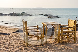Bamboo chairs and table with clear sky on Pak Weep beach in the evening