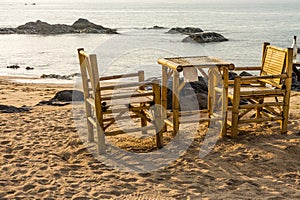 Bamboo chairs and table on Pak Weep beach in the evening
