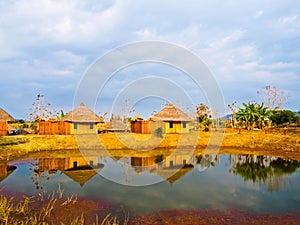 Bamboo cottages and and thier reflections in pond in Nakorn Ratchasima,Thailand