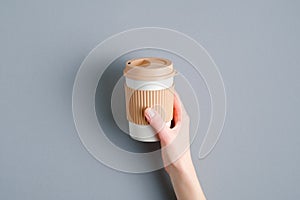 Bamboo cup in female hand. Eco-friendly takeaway coffee mug. Top view