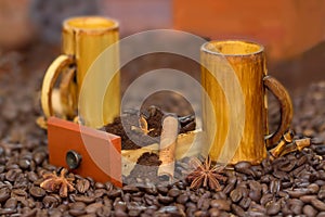 Bamboo cups and coffee beans, cofee grinded in wood box, anis and cinnamon