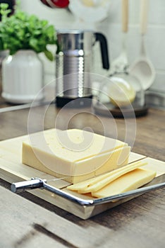 Bamboo cutting board with a built-in cheese cutting device