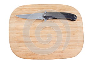 Bamboo cutting board with a knife.