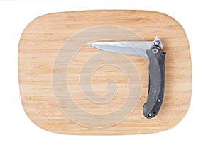 Bamboo cutting board with a knife.
