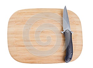 Bamboo cutting board with a knife.